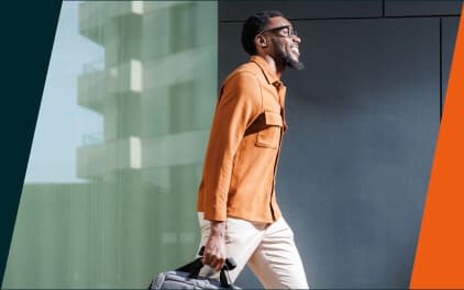 Man confidently walking to work on a sunny day.