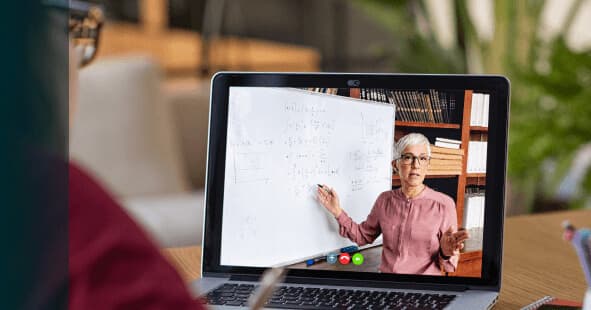 Closeup of a student watching an online lecture on their laptop.
