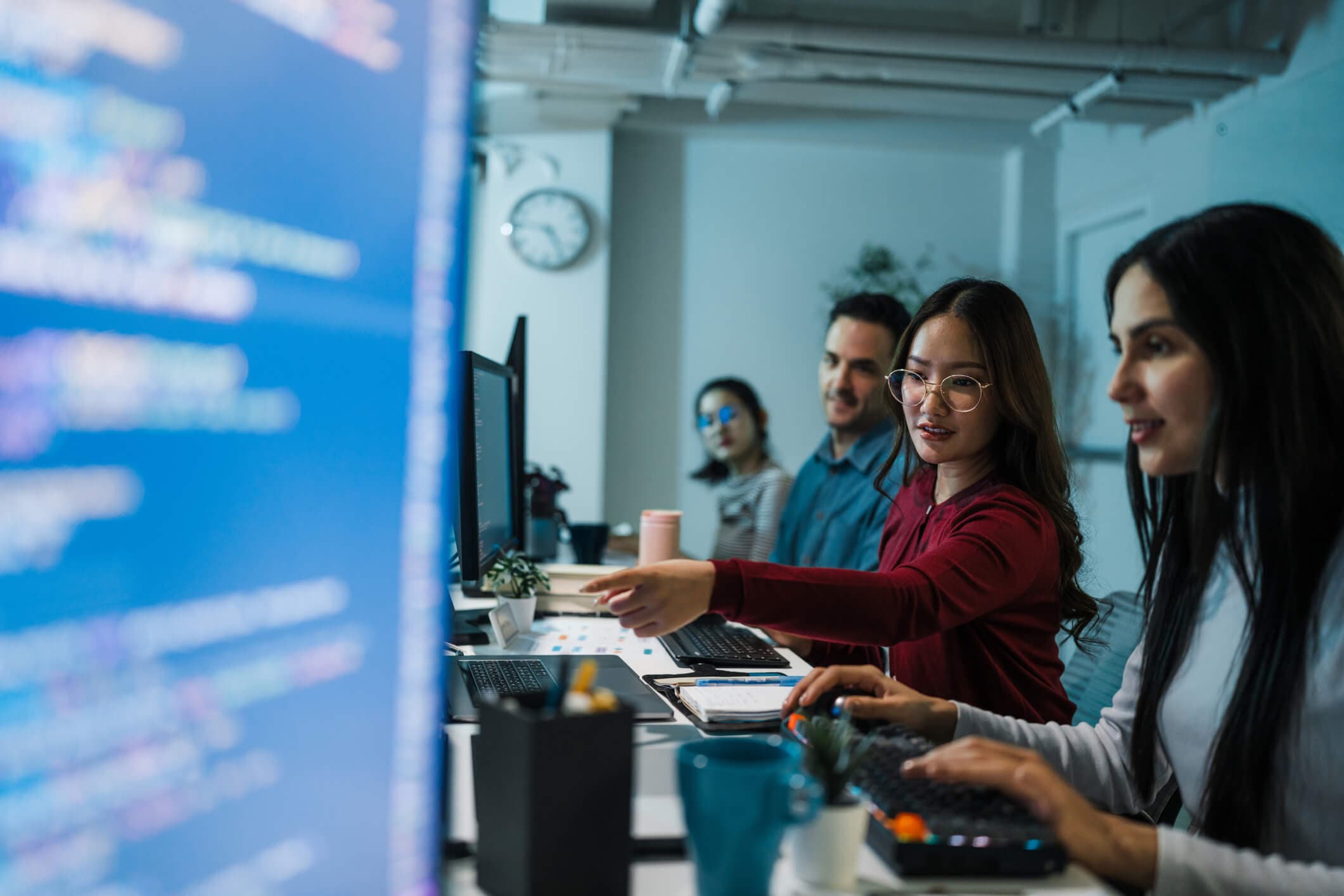Software developer colleagues working on computers together