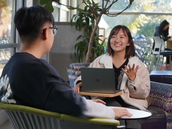 two people working with a computer